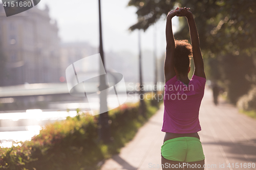 Image of Black woman doing warming up and stretching