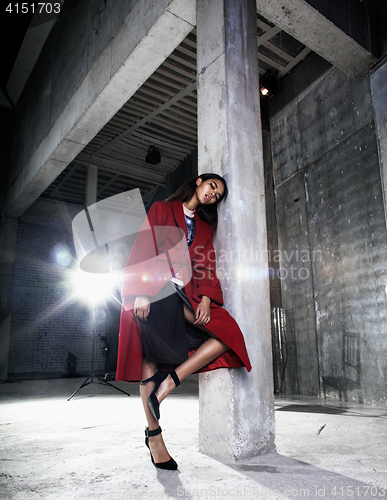 Image of young beauty african american woman in red coat  strange build