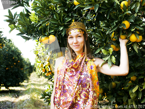 Image of pretty islam woman in orange grove smiling, real muslim girl