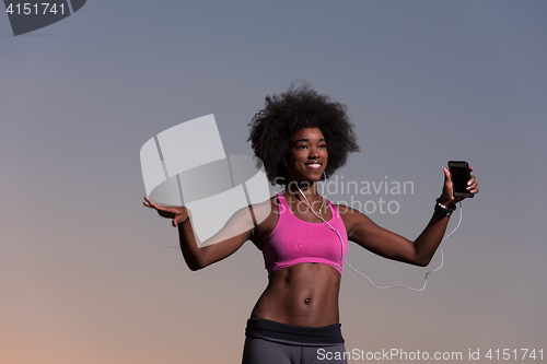 Image of young black girl dances outdoors