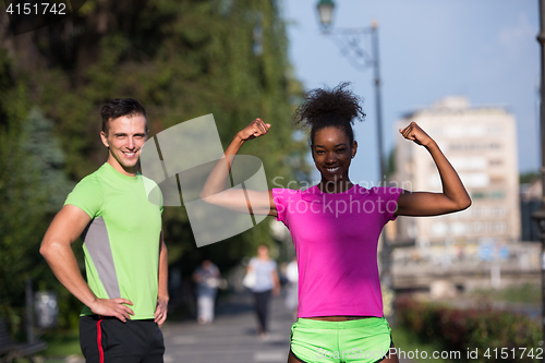 Image of portrait of young multietnic jogging couple ready to run
