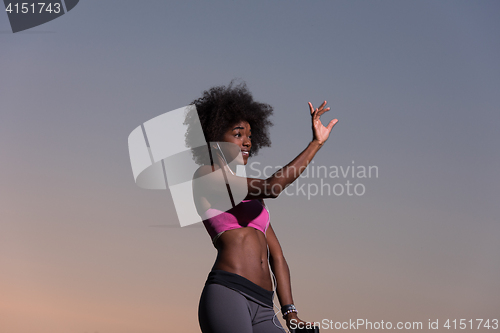 Image of young black girl dances outdoors