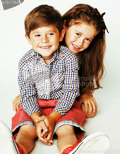 Image of little cute boy and girl hugging playing on white background, ha