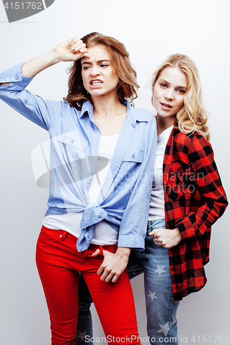 Image of two pretty blond woman having fun together on white background, mature mother and young teenage daughter, lifestyle people concept