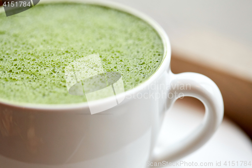 Image of close up of cup with matcha green tea latte