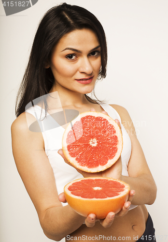 Image of beauty young brunette woman with grapefruit isolated on white background, happy smiling healthy food concept, lifestyle people