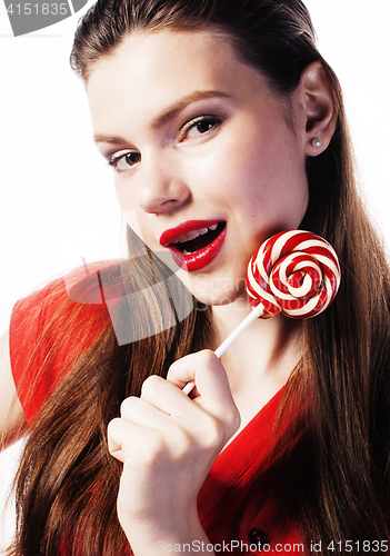 Image of young pretty brunette girl with red candy posing on white backgr