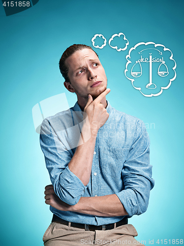 Image of The serious young man over blue background