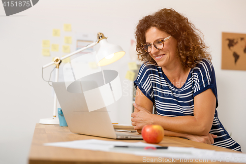 Image of Beautiful woman working at the office