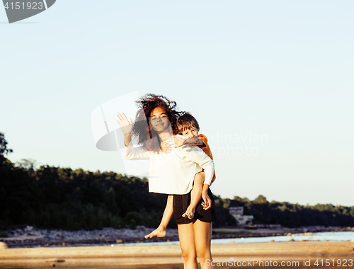 Image of pretty diverse nation and age friends on sea coast having fun, lifestyle people concept on beach vacations