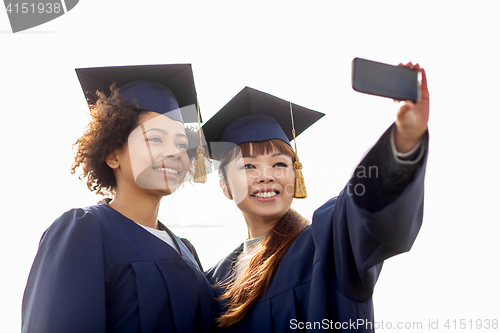 Image of students or bachelors taking selfie by smartphone