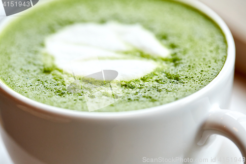 Image of close up of cup with matcha green tea latte