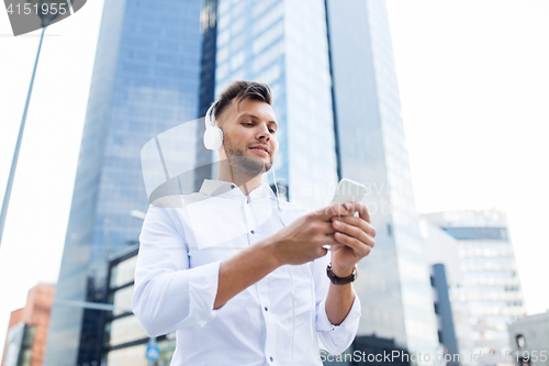 Image of man with headphones and smartphone listening music