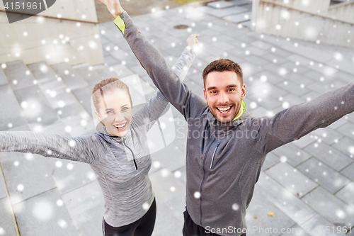 Image of happy couple of sportsmen outdoors on city street