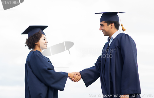 Image of happy students or bachelors greeting each other