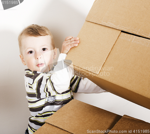 Image of portrait of little cute boy playing with box, lifestyle people concept