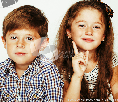 Image of little cute boy and girl hugging playing on white background, ha