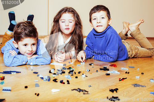 Image of funny cute children playing lego at home, boys and girl smiling, first education role lifestyle