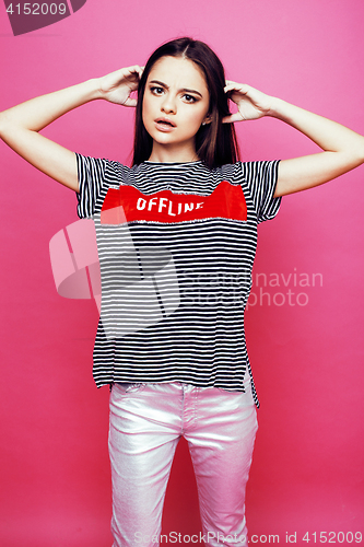 Image of young pretty teenage woman emotional posing on pink background, fashion lifestyle people concept