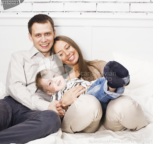 Image of young happy modern family smiling together at home. lifestyle people concept, father holding baby son