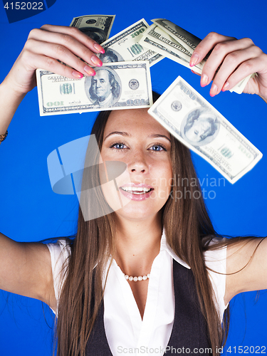 Image of pretty young brunette real modern woman with money cash on blue background happy smiling, lifestyle people concept
