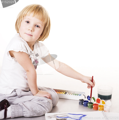 Image of little cute blond girl painting isolated on white background, lifestyle education people concept