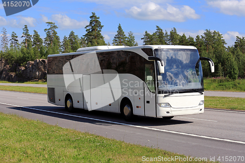 Image of White Coach Bus Travel along Freeway at Summer