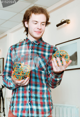 Image of Young Man Holding The Volumetric Models Of Geometric Solids