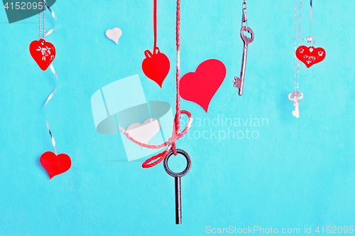 Image of Keys And Hearts Against The Turquoise Background