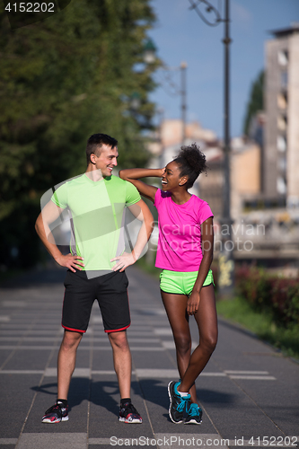 Image of portrait of young multietnic jogging couple ready to run