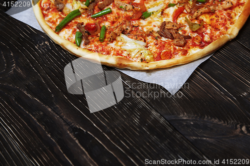 Image of Homemade pizza on a wooden table