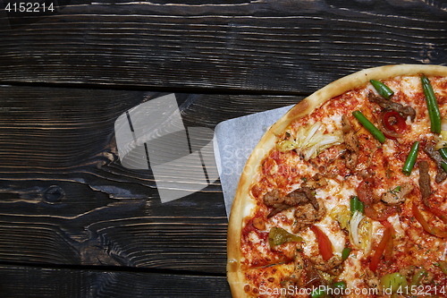 Image of Homemade pizza on a wooden table