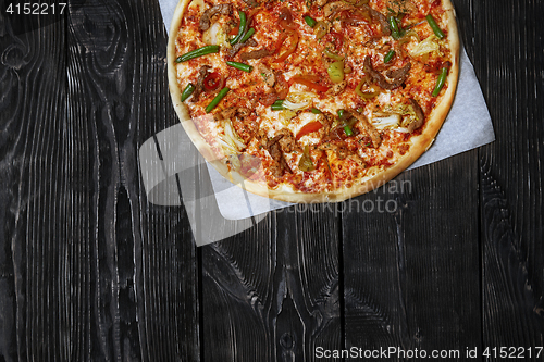 Image of Homemade pizza on a wooden table