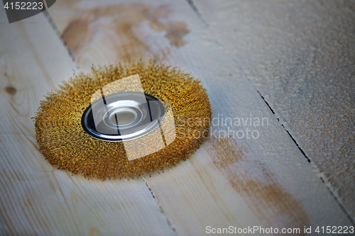 Image of Grinding disk on a wooden planks