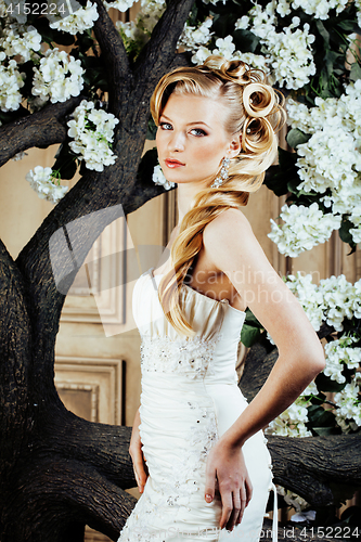 Image of beauty young bride alone in luxury vintage interior with a lot of flowers close up