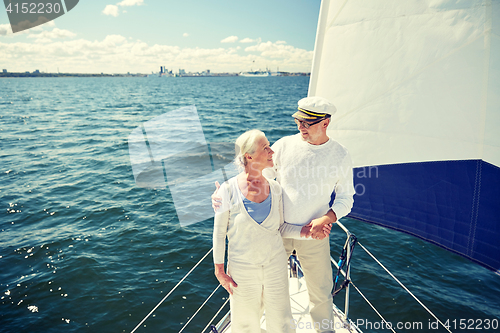 Image of senior couple hugging on sail boat or yacht in sea