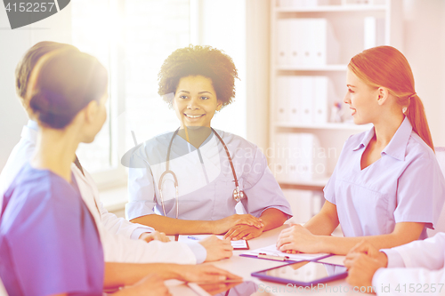 Image of group of happy doctors meeting at hospital office