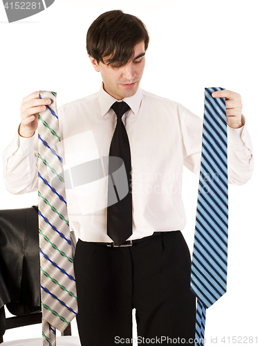 Image of young brunette handsome guy having choice between two ties isolated on white background, lifestyle business people concept