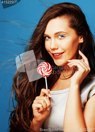 Image of young pretty adorable woman with candy close up like doll