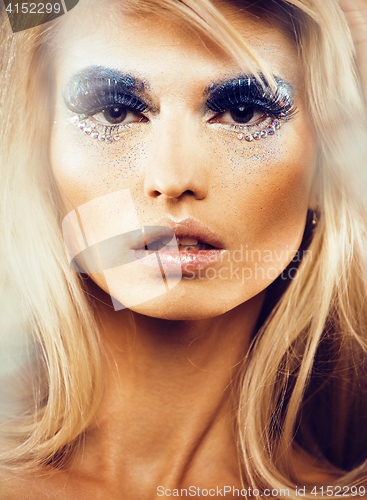 Image of beauty young snow queen in fairy flashes with hair crown on her head close up in cold blue light