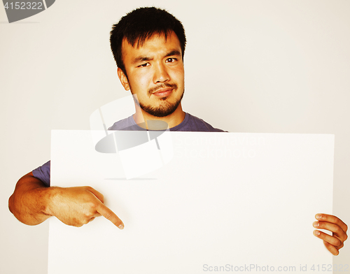 Image of pretty cool asian man holding empty white plate smiling