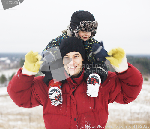 Image of portrait of happy father with his son outside in winter landscape, lifestyle people concept, real family together