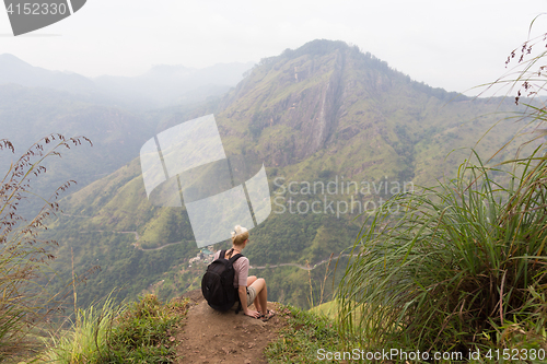 Image of Female tourist enjoying beautiful view of tea plantations, Sri Lanka.