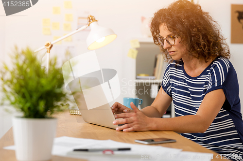 Image of Beautiful woman working at the office