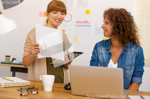 Image of Two businesswoman working together