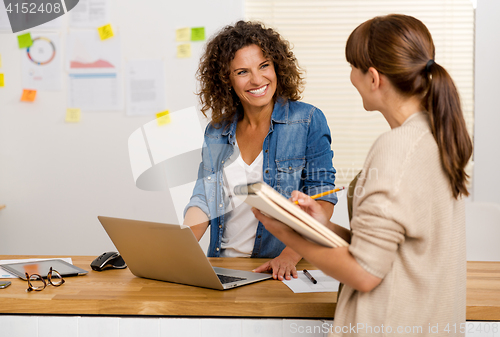 Image of Two businesswoman working together