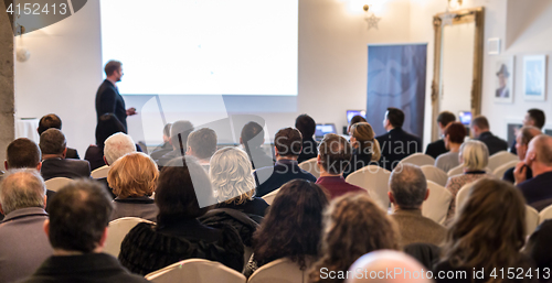 Image of Public speaker giving talk at Business Event.