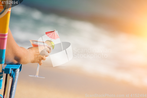 Image of Woman on Beach with Tropical Drink