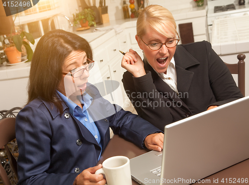 Image of Businesswomen Celebrate Success on the Laptop