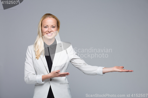 Image of Business woman showing hand sign to side.